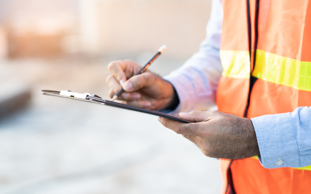 Close Up View Of A Person Writing On Clipboard